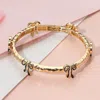 Fashnzfab Enamel Bow Accent Hammered Metal Bar Beaded Stretch Bracelet Black, Gold In Multi