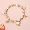 Fashnzfab Enamel Bow Metal Heart Flower Charm Ceramic Ball Beaded Stretch Bracelet In Gold