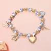 Fashnzfab Enamel Bow Metal Heart Flower Charm Ceramic Ball Beaded Stretch Bracelet In Gold