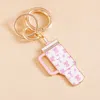 Fashnzfab Enamel Bow Pattern Tumbler Back Engraved Keychain / Bag Charm In White