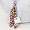 Fashnzfab Faux Leather Elegant And Stylish Mini Purse / Bag Charm With Abstract Pattern Petit Scarf In White