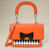 Fashnzfab Faux Leather Harlequin Pattern Bow Accent Halloween Handbag / Crossbody Bag In Orange