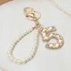 Fashnzfab Faux Leather Threaded Number Five Pearl Beaded Keychain / Bag Charm In Multi