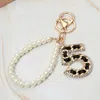 Fashnzfab Faux Leather Threaded Number Five Pearl Beaded Keychain / Bag Charm In Multi