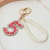 Fashnzfab Faux Leather Threaded Number Five Pearl Beaded Keychain / Bag Charm In Red