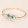 Fashnzfab Floral Encased Oval Accent Bangle Bracelet - Blue, Gold In Multi