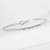 Fashnzfab Follow Your Heart Engraved Thin Brass Metal Bangle Bracelet In Multi