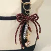 Fashnzfab Football Themed Charm Game Day Message Beaded Rope Bow Accent Keychain Bag Charm In Multi