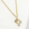 Fashnzfab Gold Dipped Cz Stone Paved Music Note Pendant Necklace In Gold