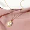 Fashnzfab Gold Dipped Cz Stone Paved Tulip Flower Embossed Mother Of Pearl Oval Pendant Necklace In Gold