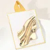 Fashnzfab Gold Dipped Modern Fluid Abstract Wave Pin Brooch In Gold