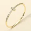 Fashnzfab Gold Plated Cz Stone Paved T-bar Hinged Bangle Bracelet In Gold