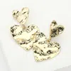 Fashnzfab Hammered Metal Heart Dangle Earrings In Gold