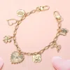 Fashnzfab Heart Butterfly Clover Bow Quatrefoil Flower Charm Station Bag Charm In Gold