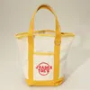 Fashnzfab Jrader Toes Message Embroidered Small Multi Purpose Canvas Tote Bag In Yellow