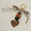Fashnzfab Leopard Bow Pom Pom Multi Beaded Resin Heart Charm Drop Keychain / Bag Charm In Brown