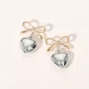 Fashnzfab Metal Bow Heart Dangle Earrings In Gold
