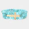 Fashnzfab Metal Cross Accented Triple Layered Semi Precious Stretch Bracelet Turquoise, Worn Gold In Blue
