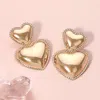 Fashnzfab Metal Double Heart Dangle Earrings In Gold