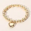 Fashnzfab Metal Heart Charm Ball Beaded Stretch Bracelet Gold In Gold
