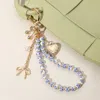 Fashnzfab Metal Heart Locket Bow Cherry Pearl Charm Floral Ceramic Ball Beaded Wristlet Keychain / Bag Charm In Multi