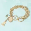 Fashnzfab Metal Oval Locket Western Boot Pearl Ceramic Tulip Charm Layered Chain Toggle Bracelet Blue, Gold In Multi