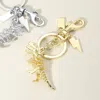 Fashnzfab Metal T-rex Dinosaur Keychain / Bag Charm In Gold