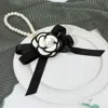 Fashnzfab Pearl Accent Floral Bow Keychain / Bag Charm In Black