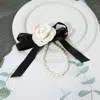 Fashnzfab Pearl Accent Floral Bow Keychain / Bag Charm In White