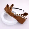 Fashnzfab Pearl Stone Embellished Bow Headband In Brown