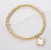 Fashnzfab Reversible Stainless Steel Quatrefoil Charm Beaded Stretch Bracelet Gold, Mother Of Pearl In Multi