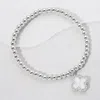 Fashnzfab Reversible Stainless Steel Quatrefoil Charm Beaded Stretch Bracelet Mother Of Pearl, Silver In Multi