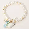 Fashnzfab Secret Box_ceramic Pigeon Metal Wishbone Pearl Beaded Stretch Bracelet Gold In Gold
