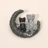 Fashnzfab Silver Dipped Rhinestone Embellished Cat And Moon Pin Brooch In Black
