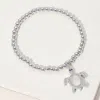 Fashnzfab Stainless Steel Ball Mother Of Pearl Sea Turtle Charm Beaded Stretch Bracelet Mother Of Pearl, Silve In Multi