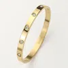 Fashnzfab Stainless Steel Crystal Embellished Bangle Bracelet In Gold