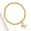 Fashnzfab Stainless Steel Cz Stone Accent Mother Of Pearl Butterfly Charm Stretch Bracelet Gold, Mother Of Pea In Multi