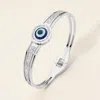 Fashnzfab Stainless Steel Cz Stone Paved Evil Eye Accent Hinged Bangle Bracelet - Silver In Multi