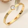 Fashnzfab Stainless Steel Heart Stone Accent Hinged Bangle Bracelet In Gold