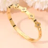 Fashnzfab Stainless Steel Stone Accent Quatrefoil Motif Hinged Bangle Bracelet In Gold