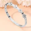 Fashnzfab Stainless Steel Stone Accent Quatrefoil Motif Hinged Bangle Bracelet In Metallic