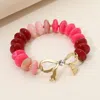 Fashnzfab Stone Accent Metal Bow Accent Flat Resin Disc Beaded Stretch Bracelet In Pink