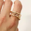 Fashnzfab Stone Paved Band Accent Triple Link Band Ring In Gold