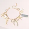Fashnzfab Stone Paved Bow Metal Starfish Fish Shell Pearl Tropical Leaf Charm Station Bracelet Clear, Gold In Multi