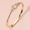 Fashnzfab Stone Paved Buckle Accent Hinged Bangle Bracelet Clear, Gold In Gold