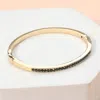 Fashnzfab Stone Paved Hinged Bangle Bracelet Black Diamond, Gold In Multi