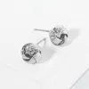 Fashnzfab Textured Metal Love Knot Stud Earrings - Rhodium In Silver