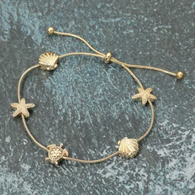 Fashnzfab Textured Metal Starfish Shell Turtle Station Cinch Pull Tie Bracelet In Gold