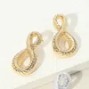 Fashnzfab Textured Metal Twisted Loop Earrings - Gold In Gold