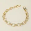 Fashnzfab Twisted Metal Oval Link Chain Bag Charm In Gold